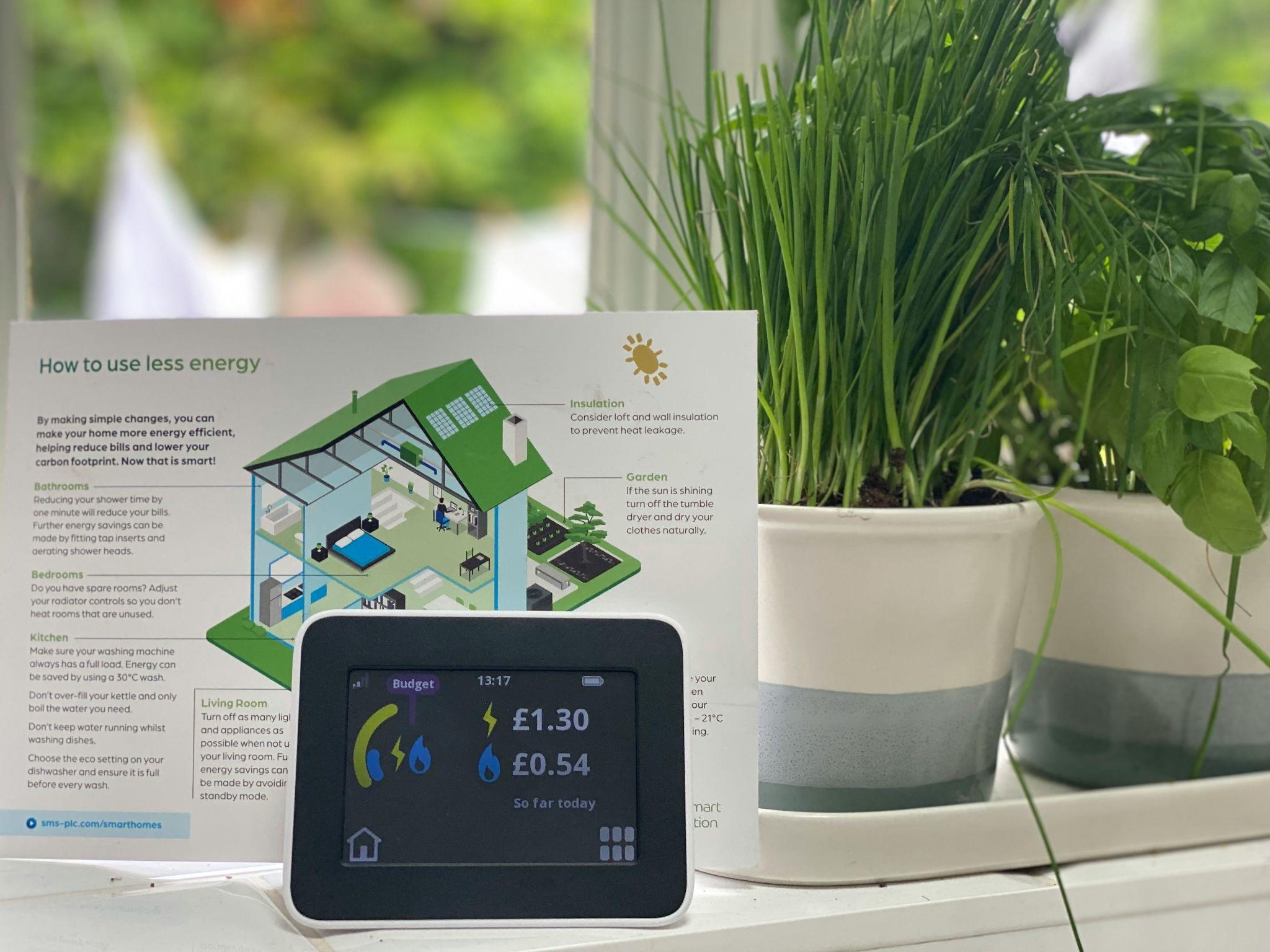 A smart energy monitor displays household usage, highlighting the benefits of energy efficiency services in Fresno.