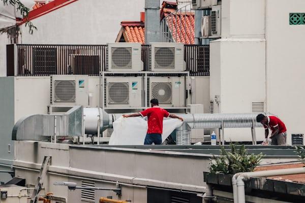 Technician inspecting air conditioning components during a Porterville tune-up