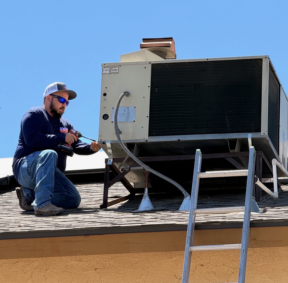 A&G technician servicing a rooftop package HVAC unit