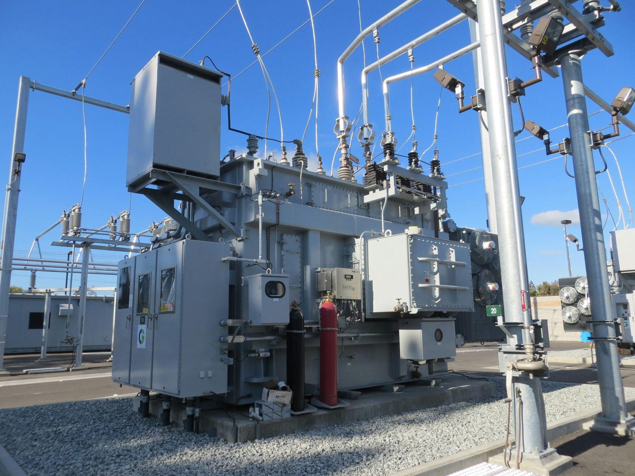 A large electrical transformer at a power substation highlights the importance of dependable electricity from whole home backup generators in Fresno.