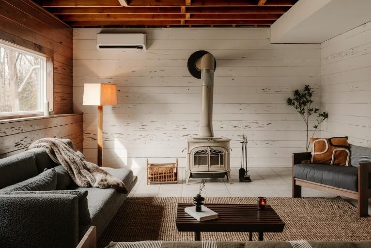 Energy-efficient mini split heat pump mounted by residential heating services in Central Valley in a rustic-style living room.
