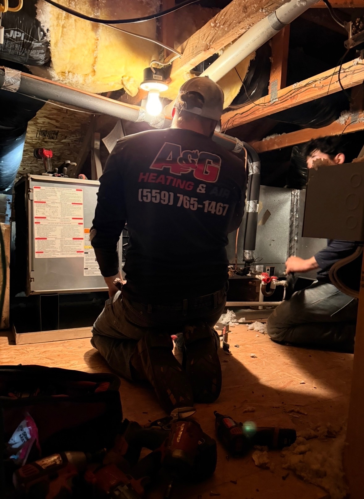 A&G technicians installing a furnace and air handler in an attic