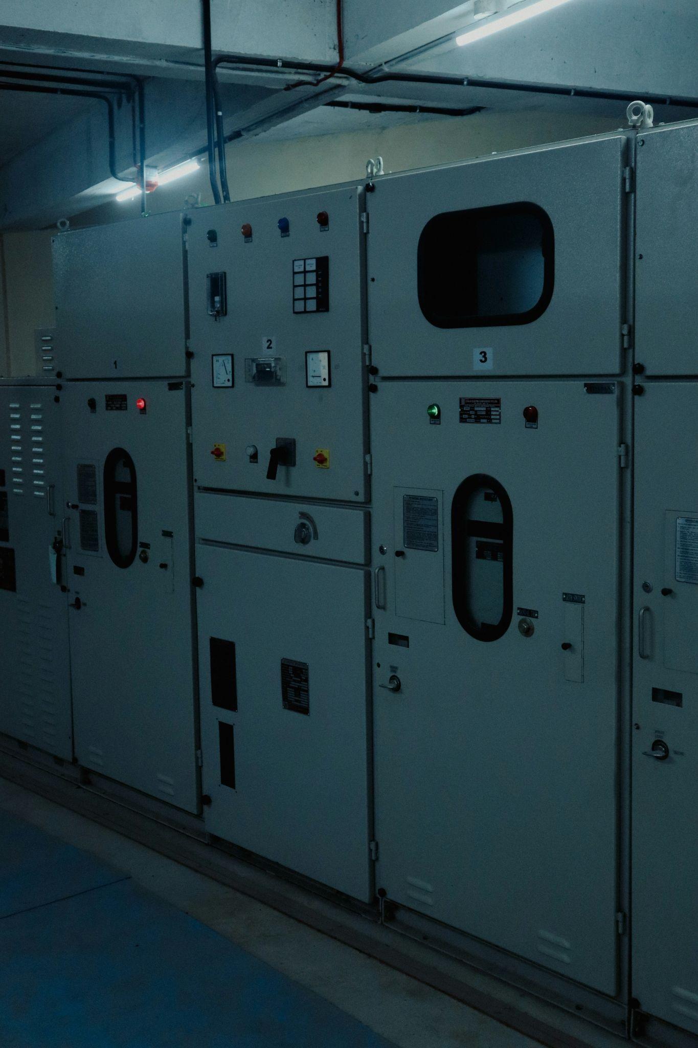 Electrical control panels are shown in an industrial setting, representing equipment involved in home backup generators installation in Fresno.