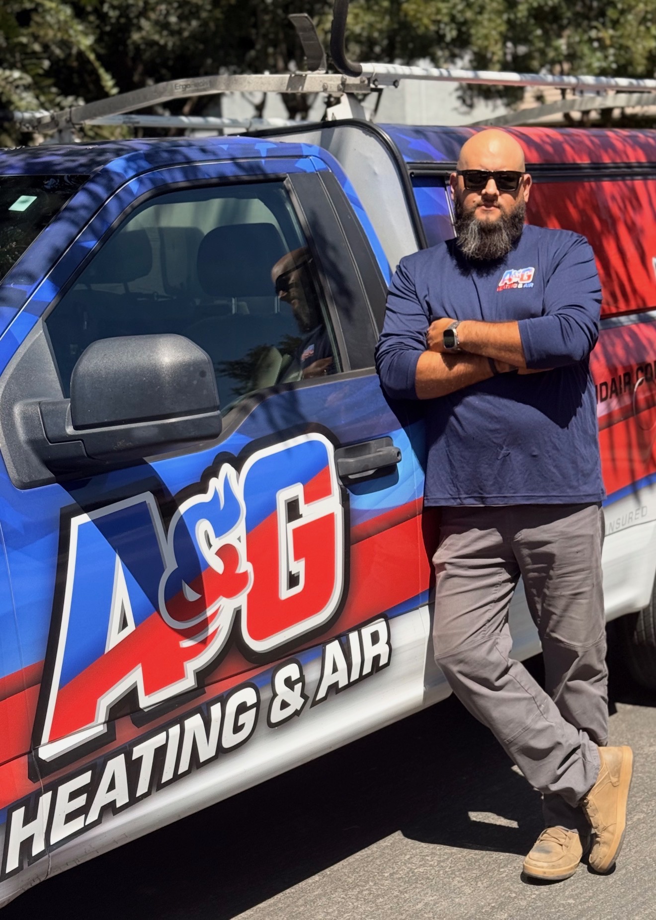 A&G Heating & Air owner beside the company service truck in Fresno, CA